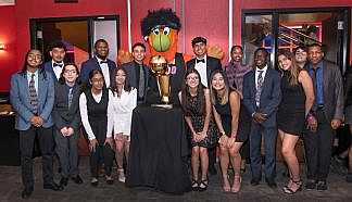 Scholarship group with Burnie and the NBA trophy.