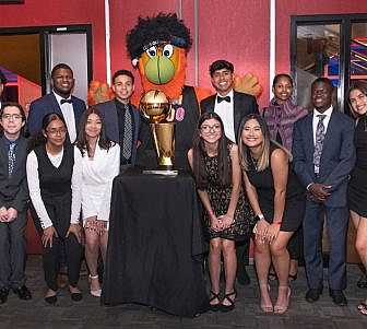 Scholarship group with Burnie and the NBA trophy.