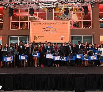 Scholarship group with their laptops and certificate.